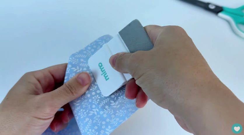 Colando o tecido na caixa com a Espátula Mimo