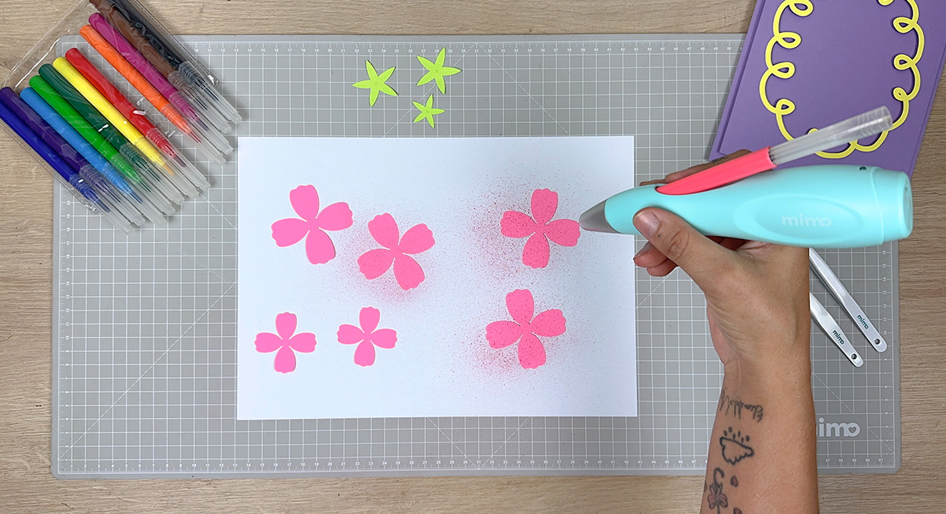 Usando o aerógrafo nas pétalas da flor de papel Usando o aerógrafo nas pétalas da flor de papel